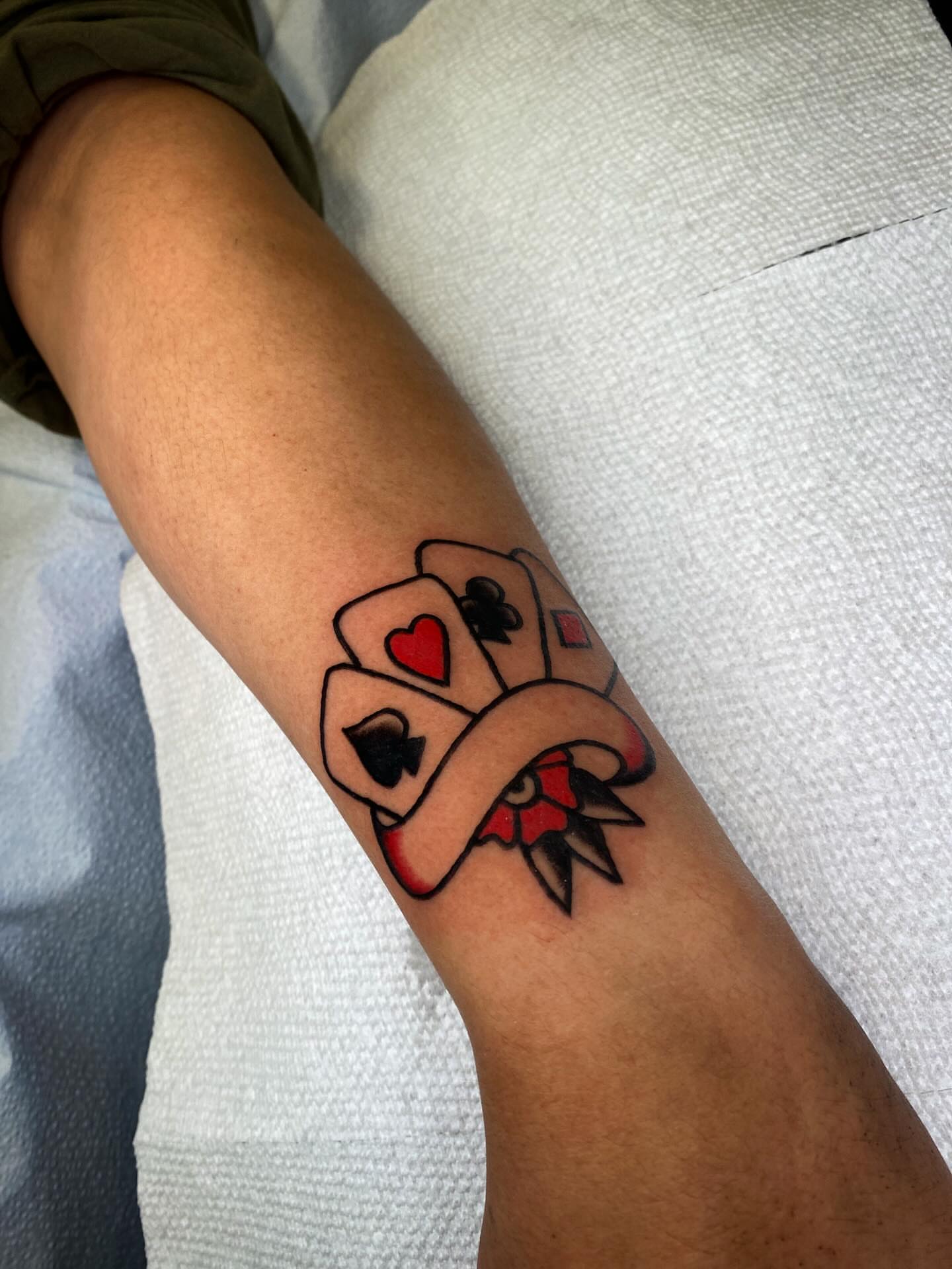 Playing cards American traditional tattoo on the forearm by @rubber_band_dan, San Francisco, California