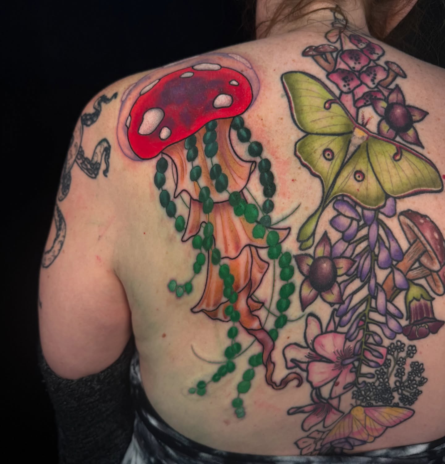 Mushroom and flowers new school tattoo on the back by Pam Sanders
