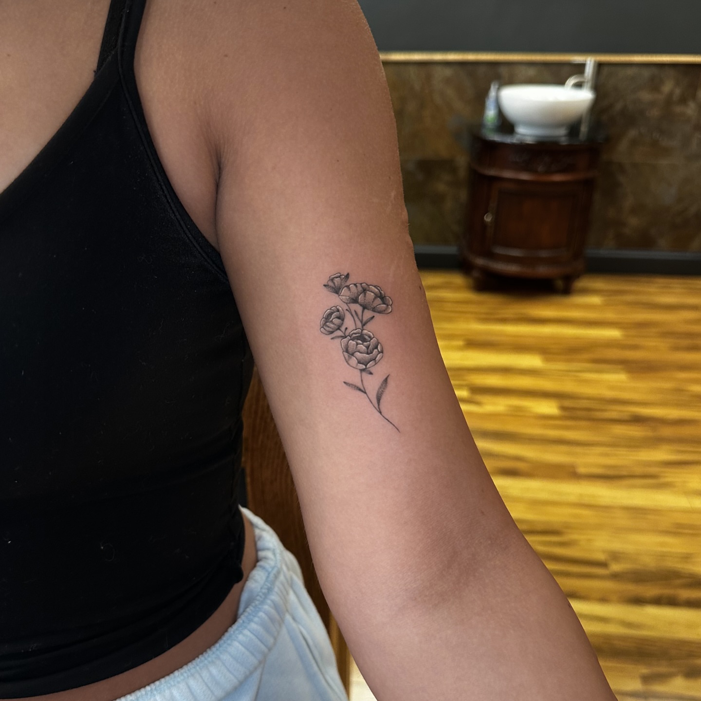 Flowers black and grey tattoo on the forearm by Leo Fernandes, Danvers, Massachusetts