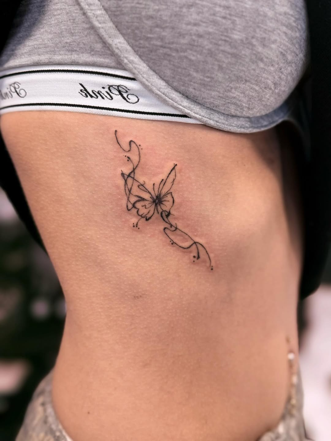 Abstract butterfly fine line tattoo on the ribs by ❦julia