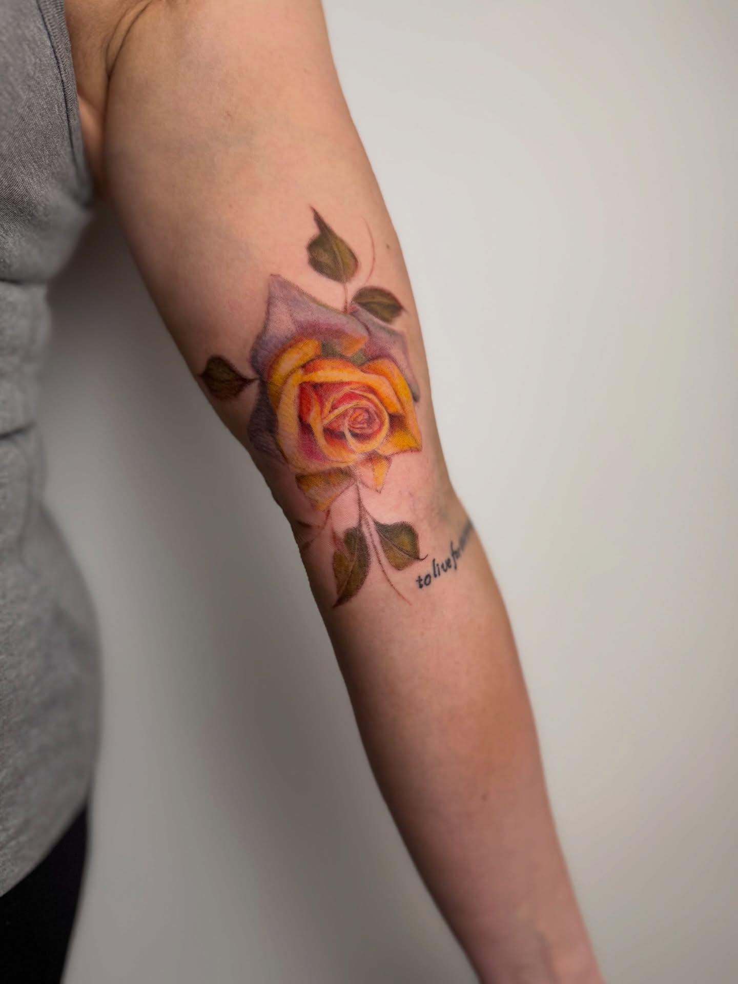 Rose realism tattoo on the forearm by Mackenzie