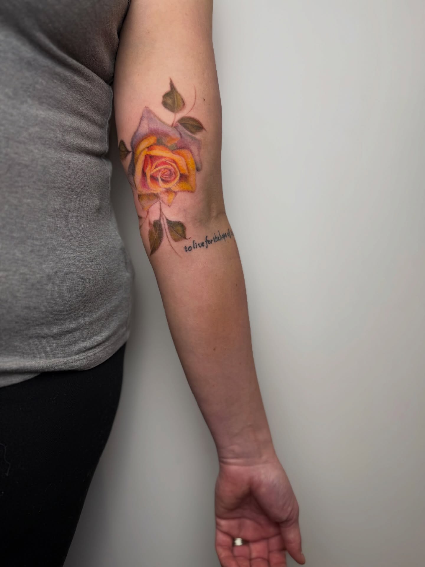 Rose watercolor tattoo on the forearm by Mackenzie