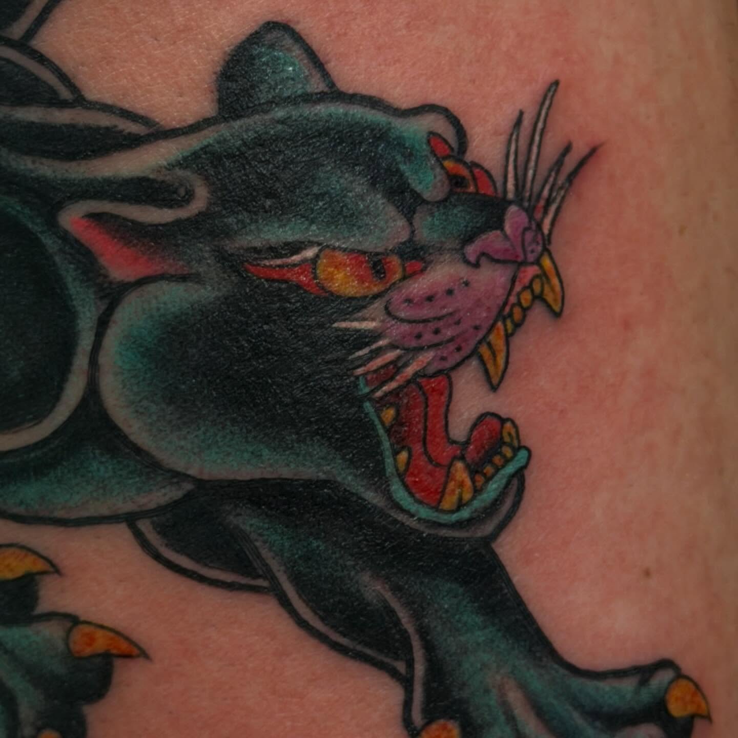 Panther American traditional tattoo on the upper arm by Madilynn Klassen