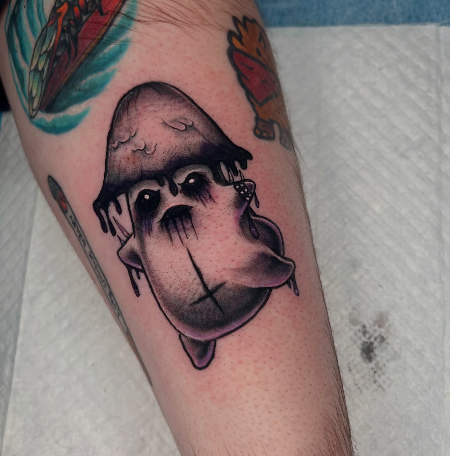 Melting clown face American traditional tattoo on the forearm by Brandon Durbin