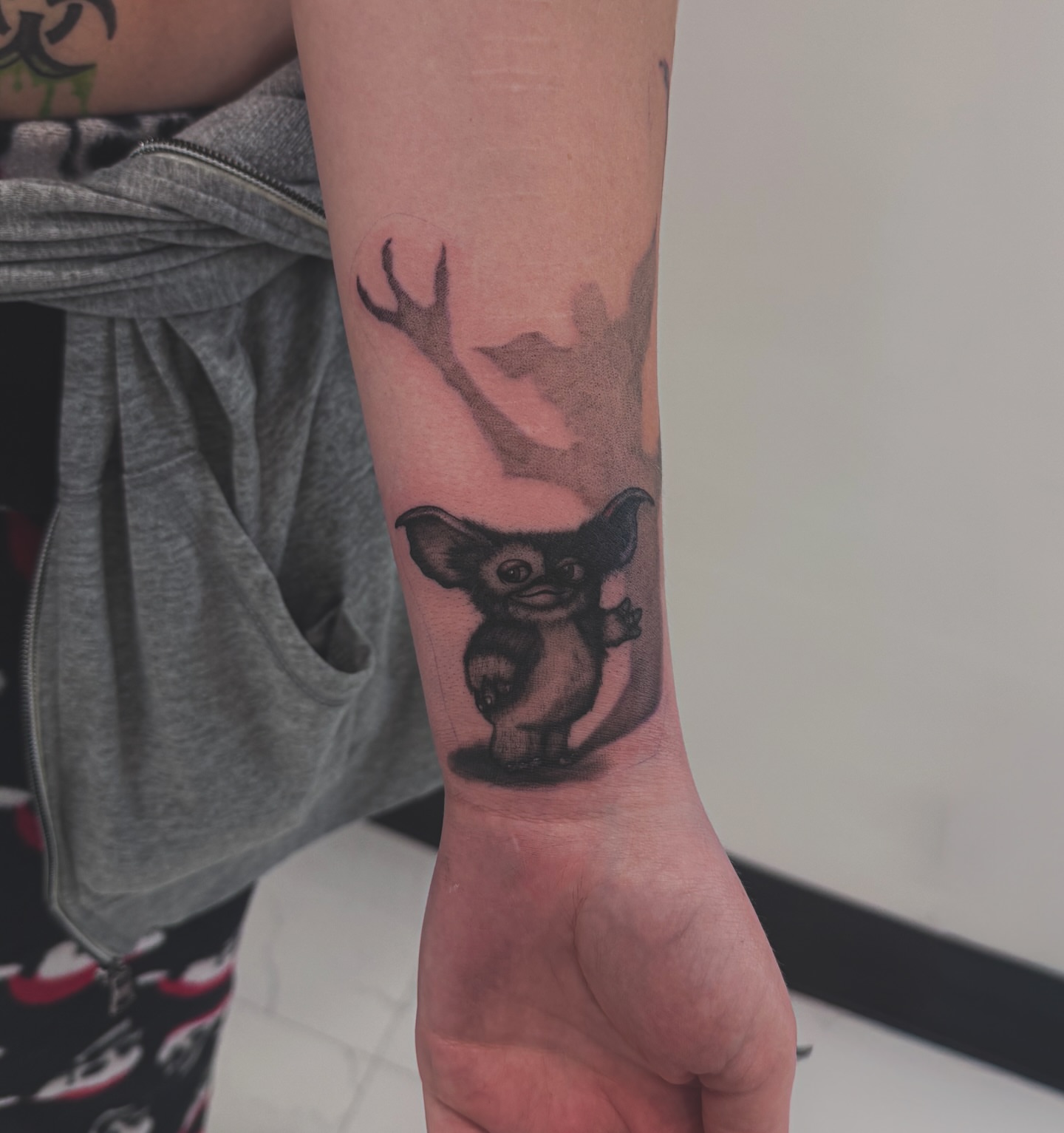 Gremlin black and grey tattoo on the forearm by utah tattoo artist