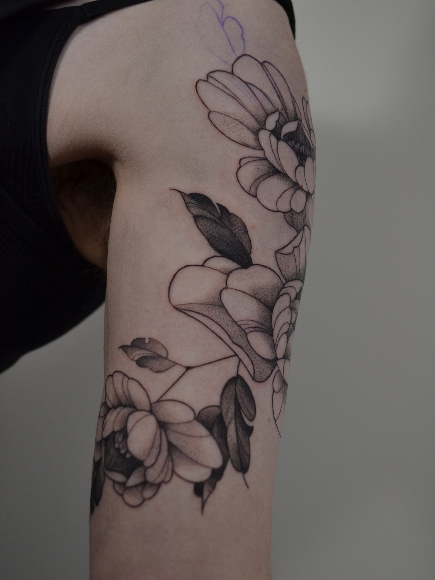 Floral arrangement black and grey tattoo on the forearm by Vanessa Acosta
