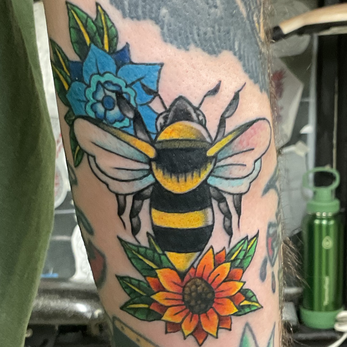 Bee and sunflower American traditional tattoo on the forearm by Roachrude