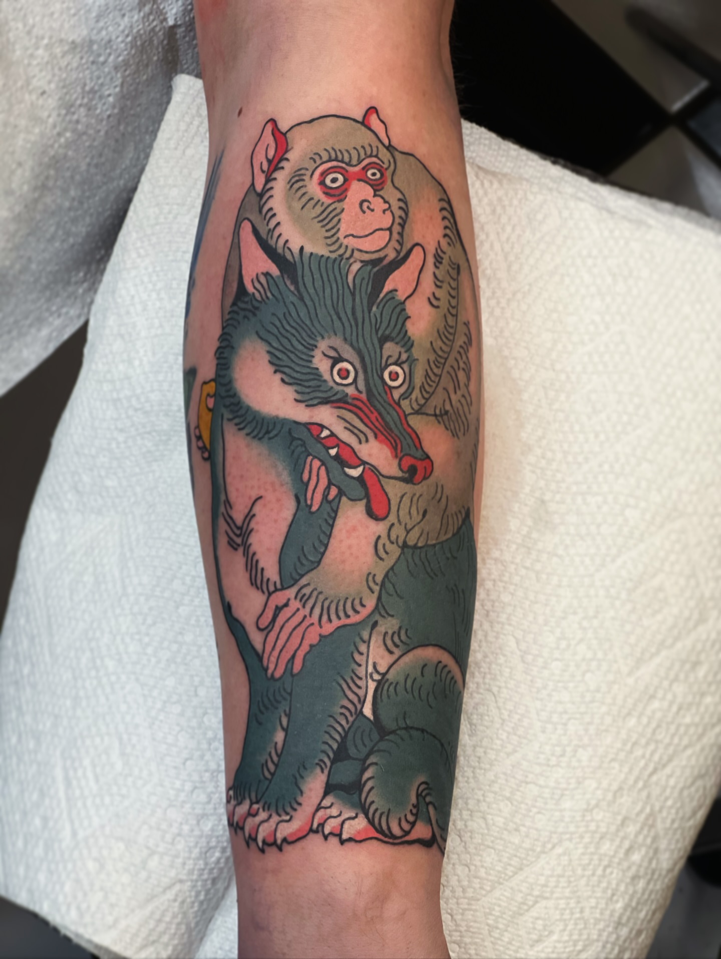 Monkey and wolf American traditional tattoo on the forearm by superteal