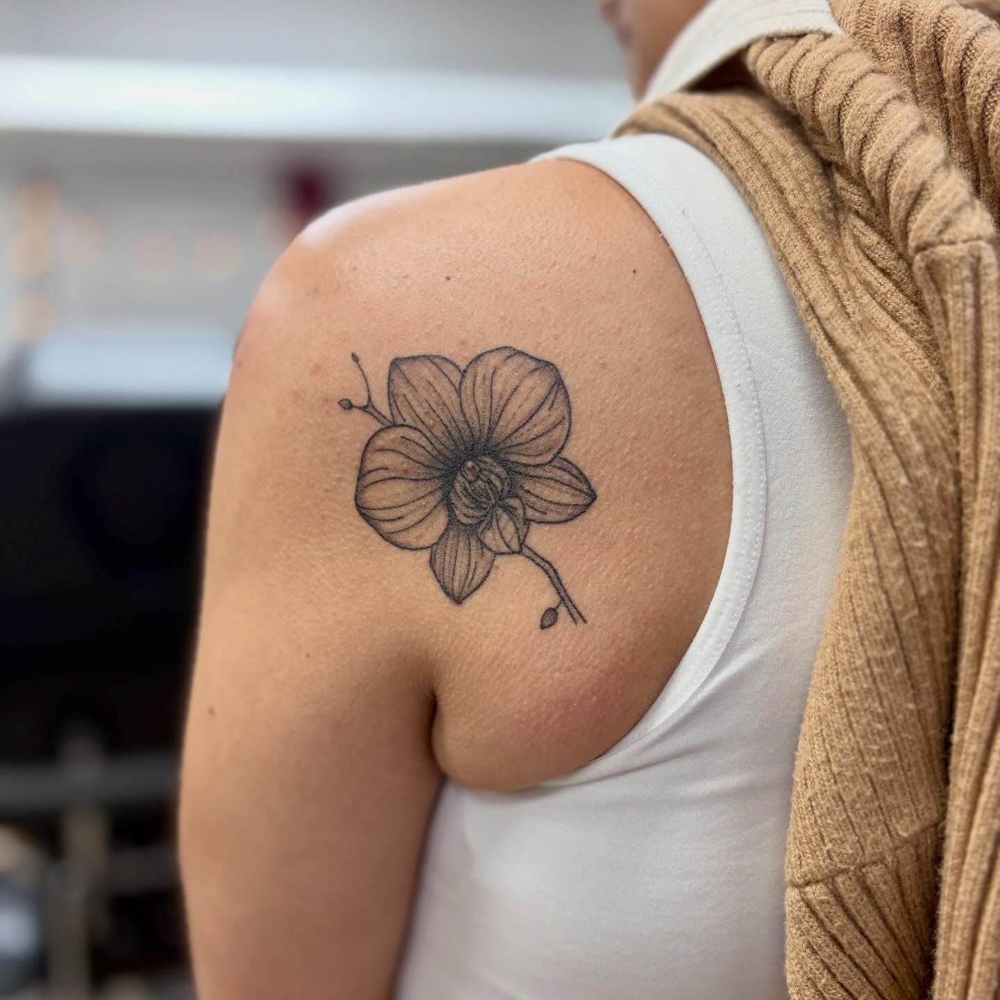 Orchid black and grey tattoo on the shoulder by bradyn thornton: eco-tattoo artist