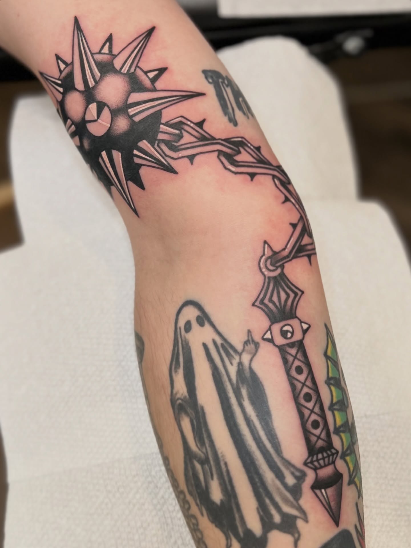 Ghost and spiked weapon American traditional tattoo on the forearm by Lauren Alexandra