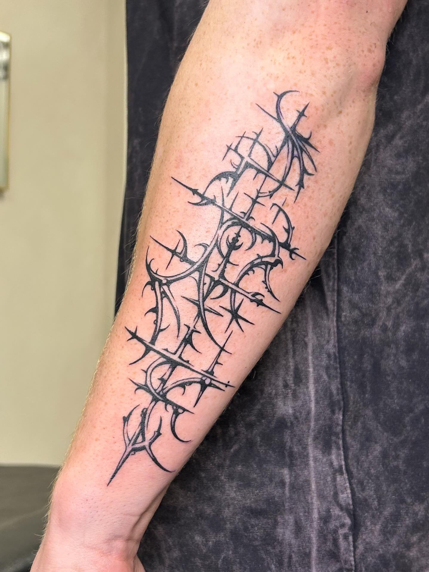 Thorn crown black and grey tattoo on the forearm by kuna ink