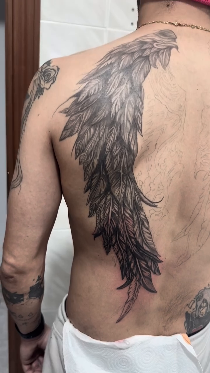 Large feather tattoo on back realism tattoo on the back by Kunaytattoo