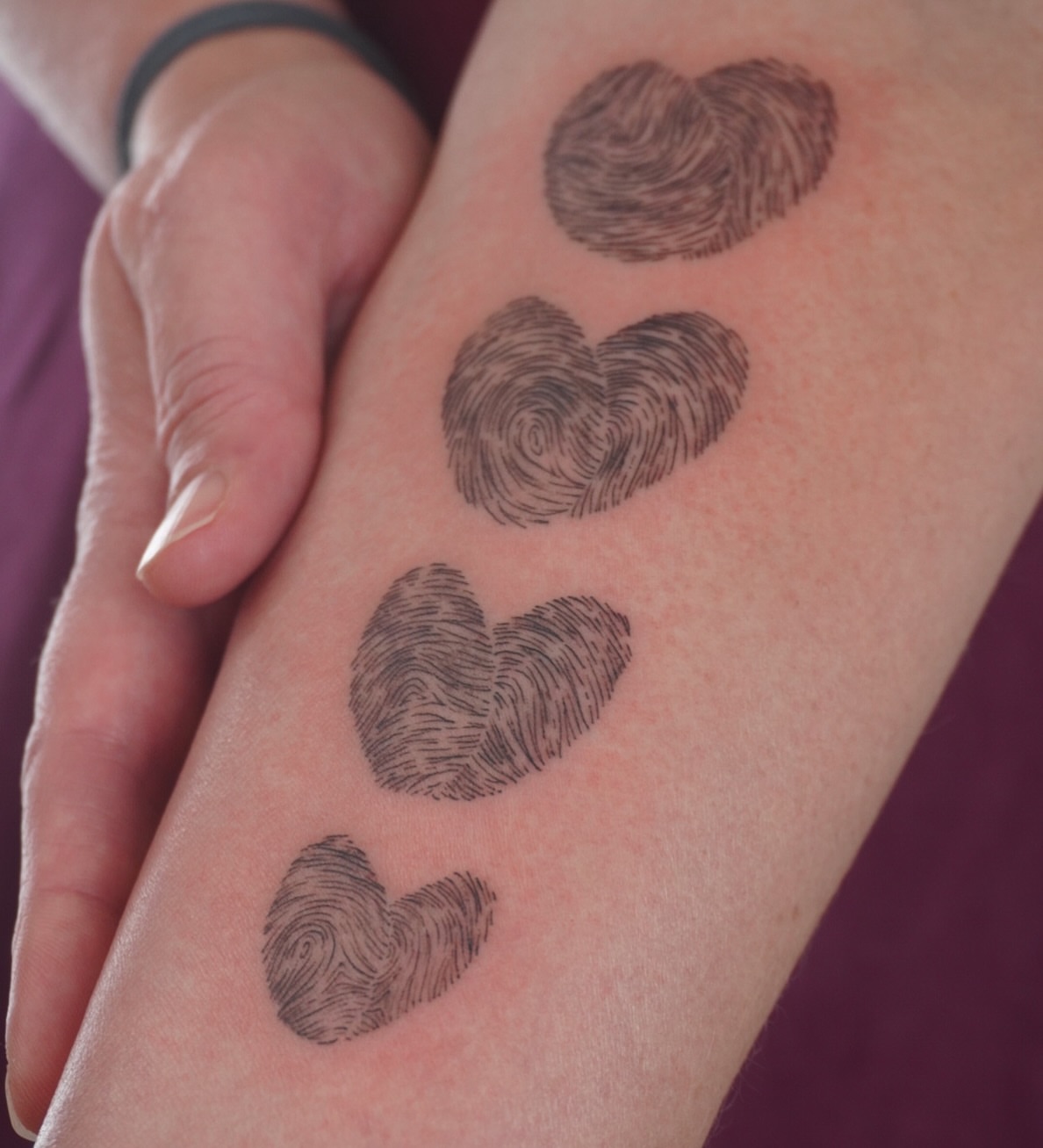 Fingerprint hearts dotwork tattoo on the forearm by Sun Child Tattoo 🌻