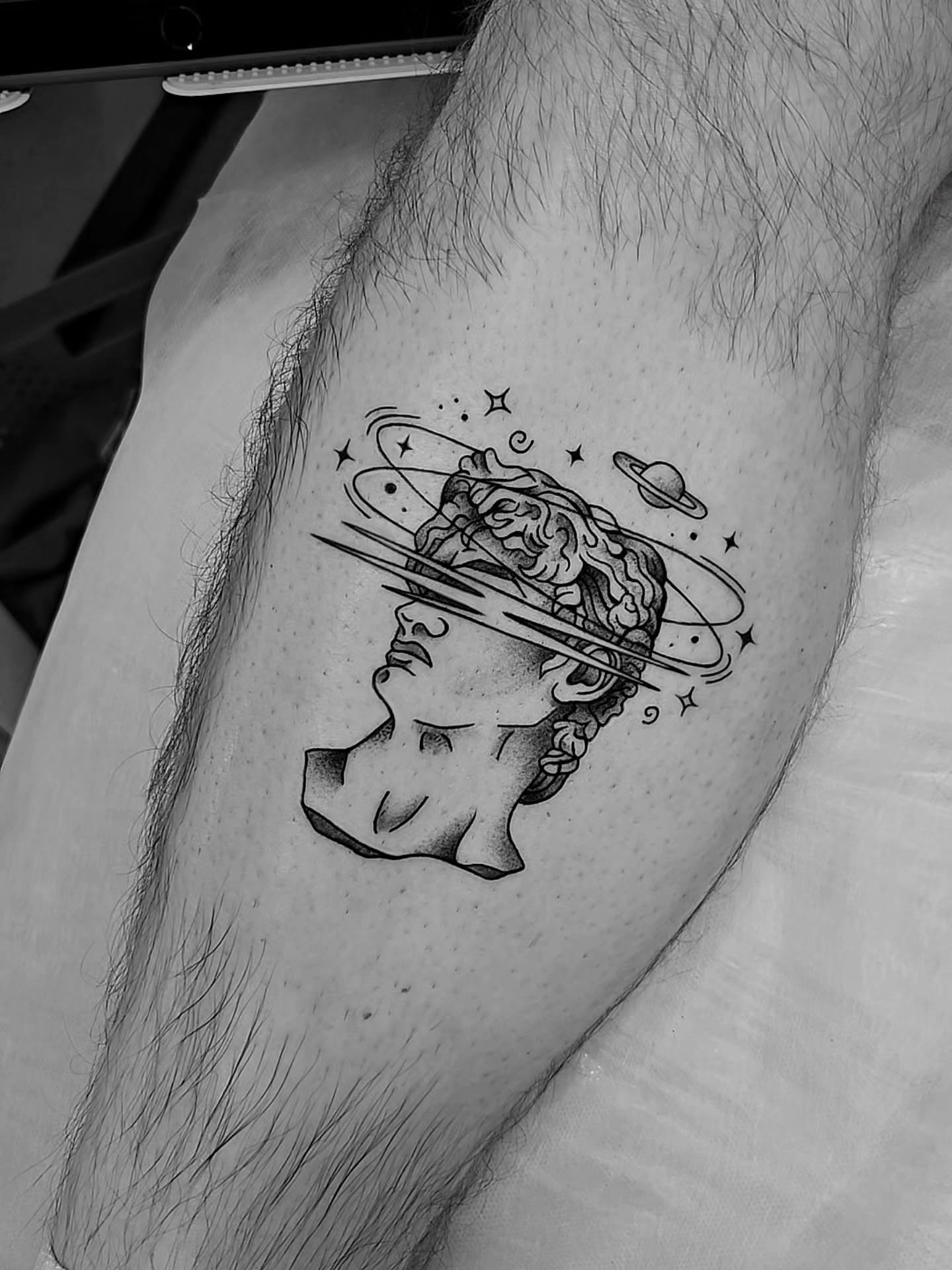 Astronaut helmet dotwork tattoo on the thigh by Kirstie Lew Tattoo