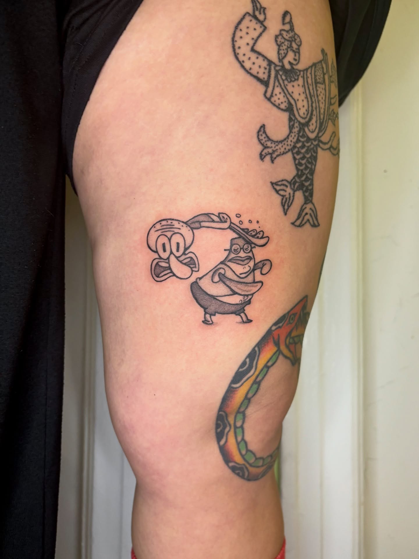 Mermaid and fish black and grey tattoo on the thigh by Grae