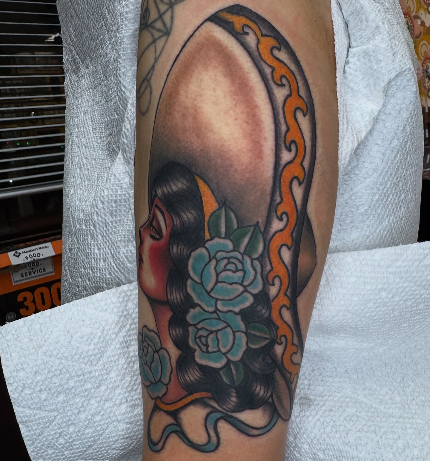Woman with roses American traditional tattoo on the forearm by Lisa Del Toro