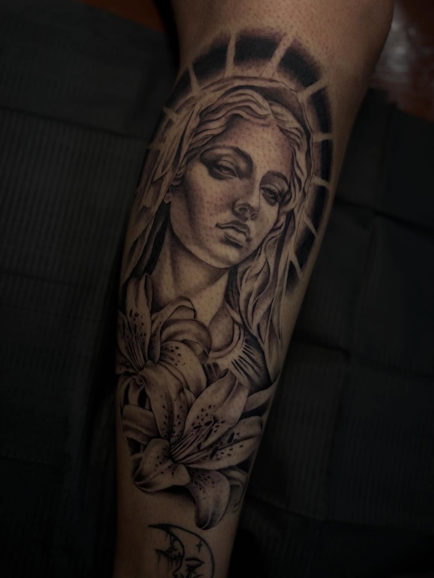 Woman with lilies realism tattoo on the forearm by Alexandria