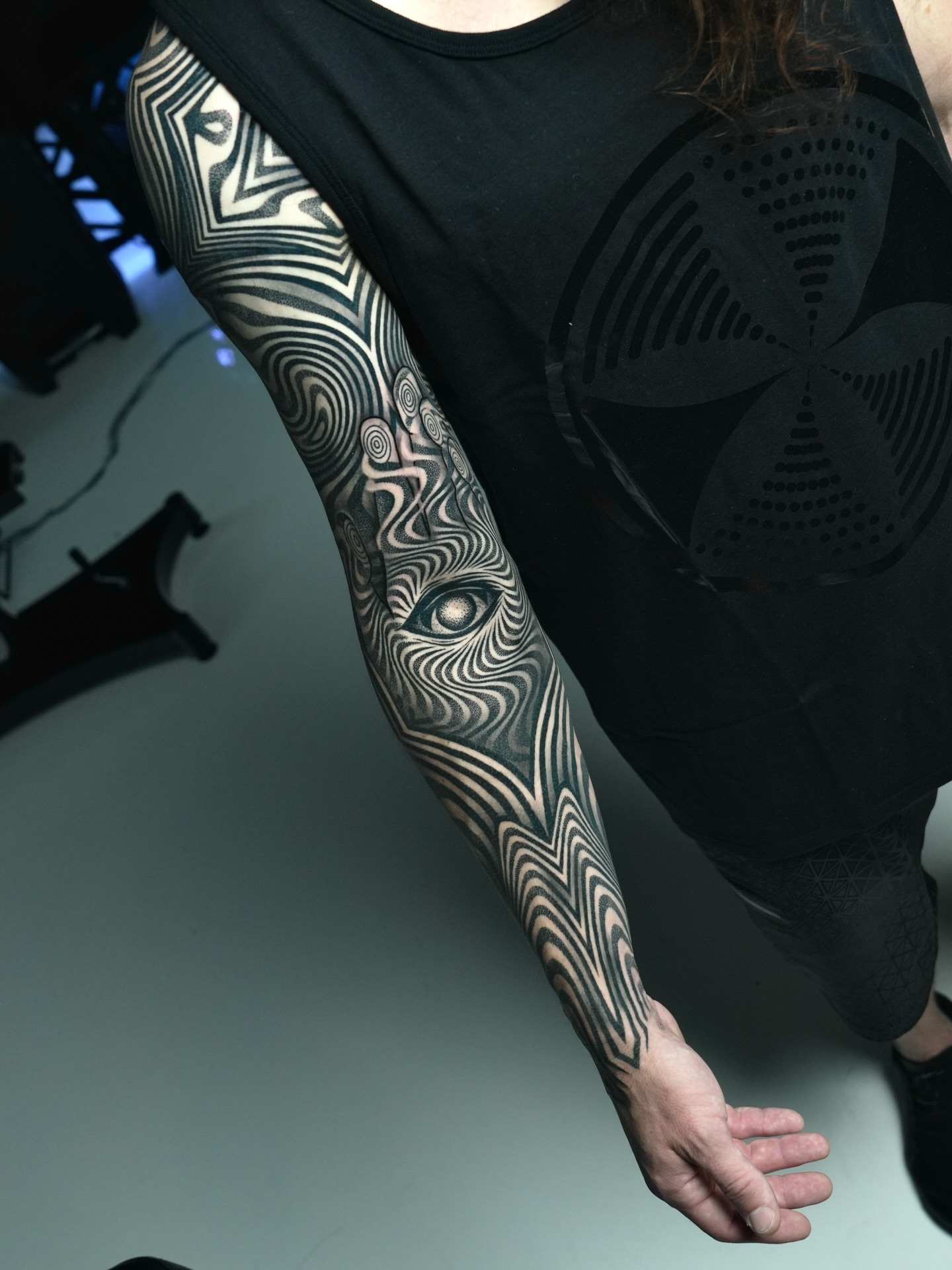 Abstract eye and patterns surrealism tattoo on the forearm by Ilya Cascad Kandaurov