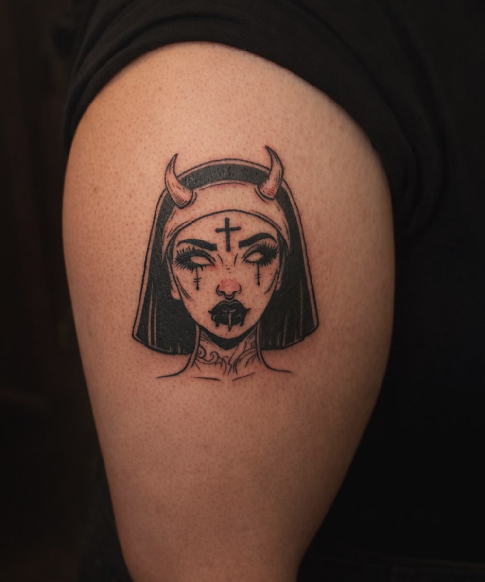 Woman with horns black and grey tattoo on the shoulder by Shampooh