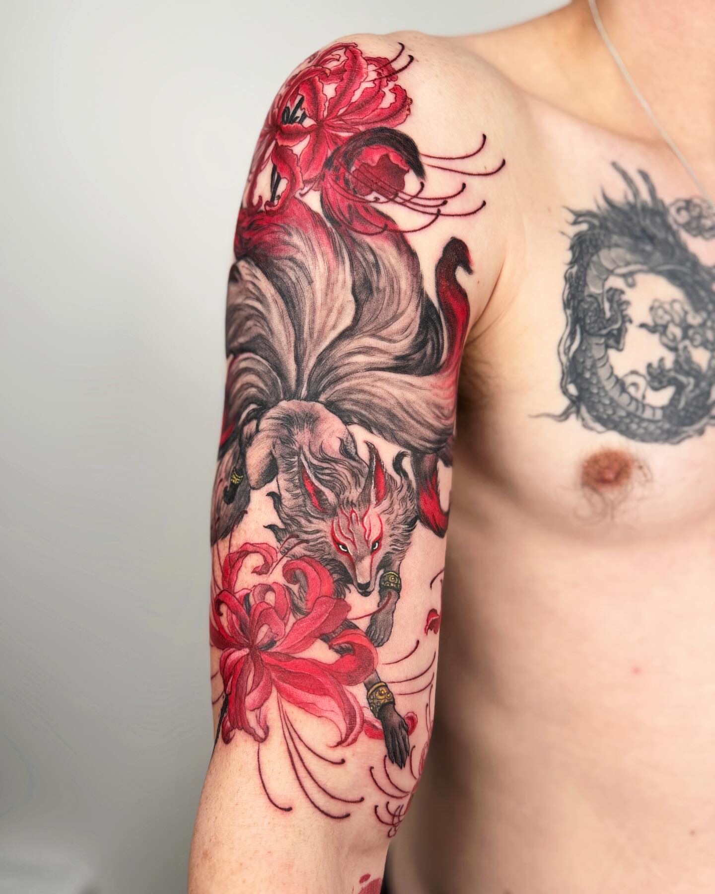 Fox and flowers japanese irezumi tattoo on the upper arm by Jiang_Tattooer