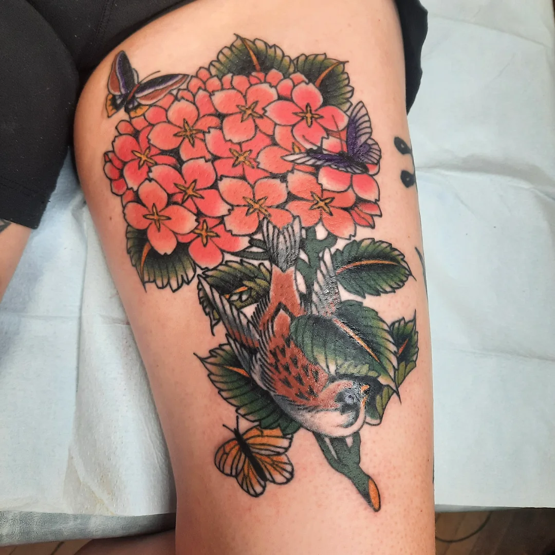 Koi fish and flowers American traditional tattoo on the thigh by Kaetlyn