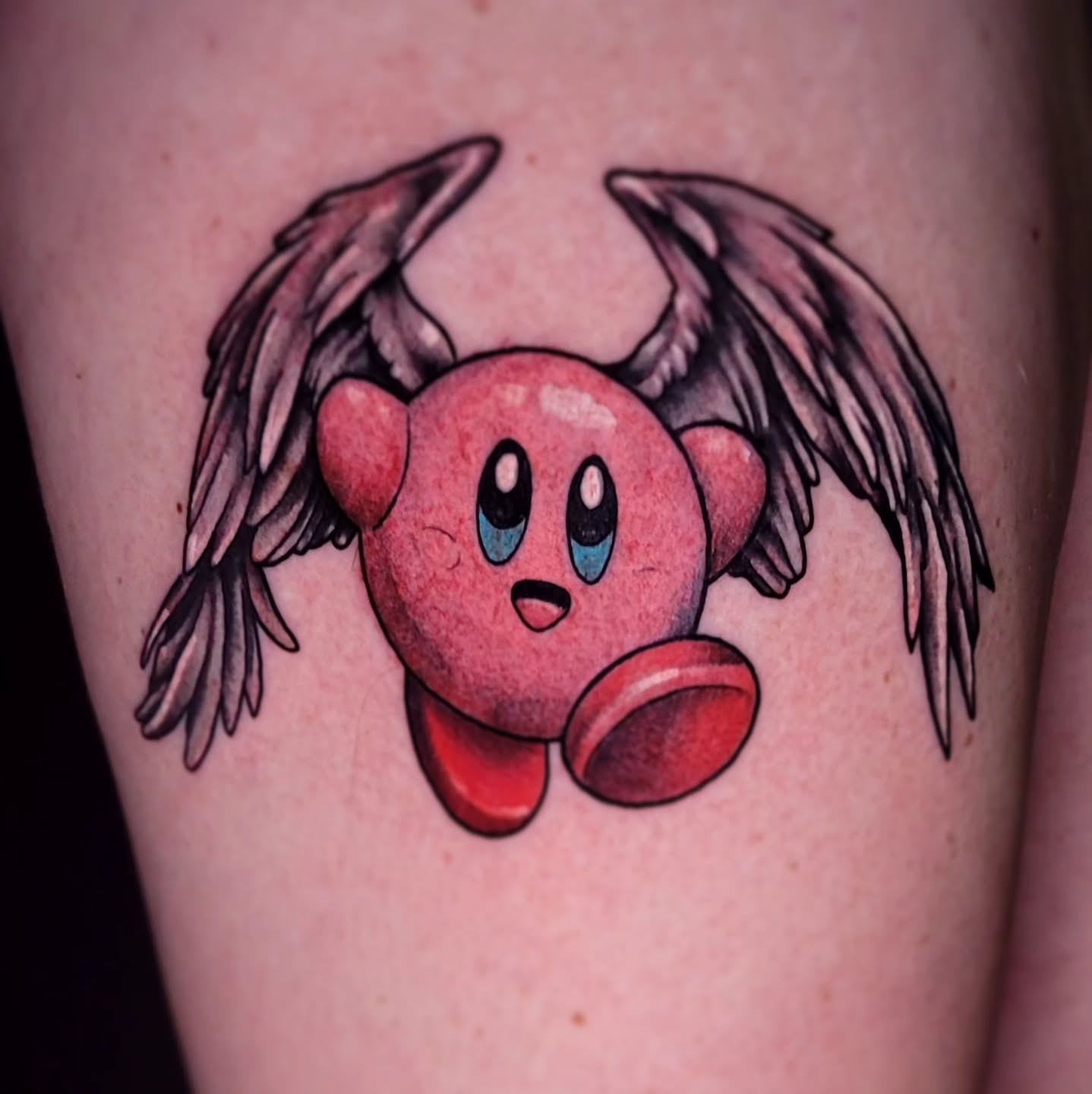 Kirby with wings anime tattoo on the thigh by Tyler Monty