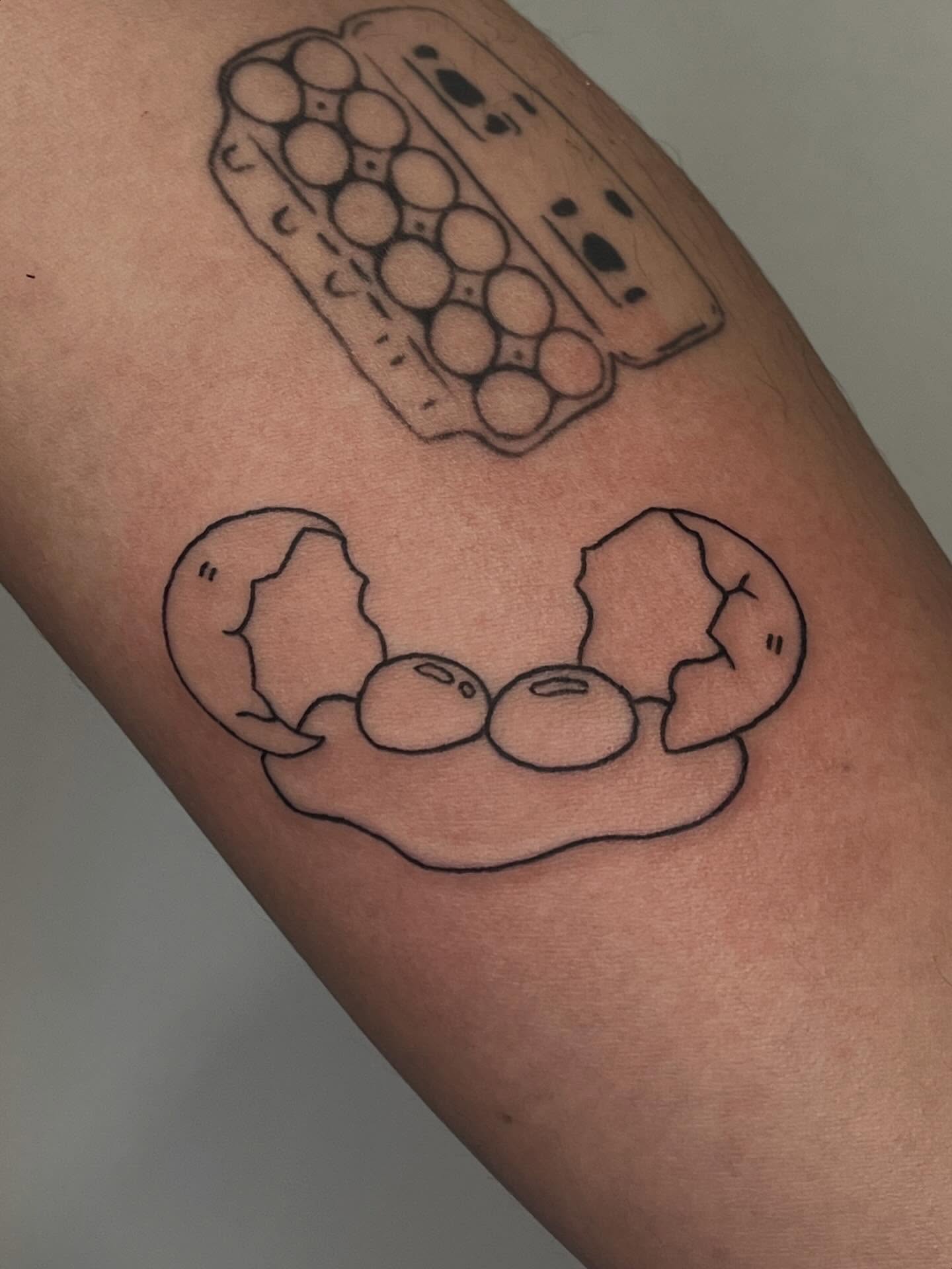 Eggs black and grey tattoo on the forearm by ashley π²