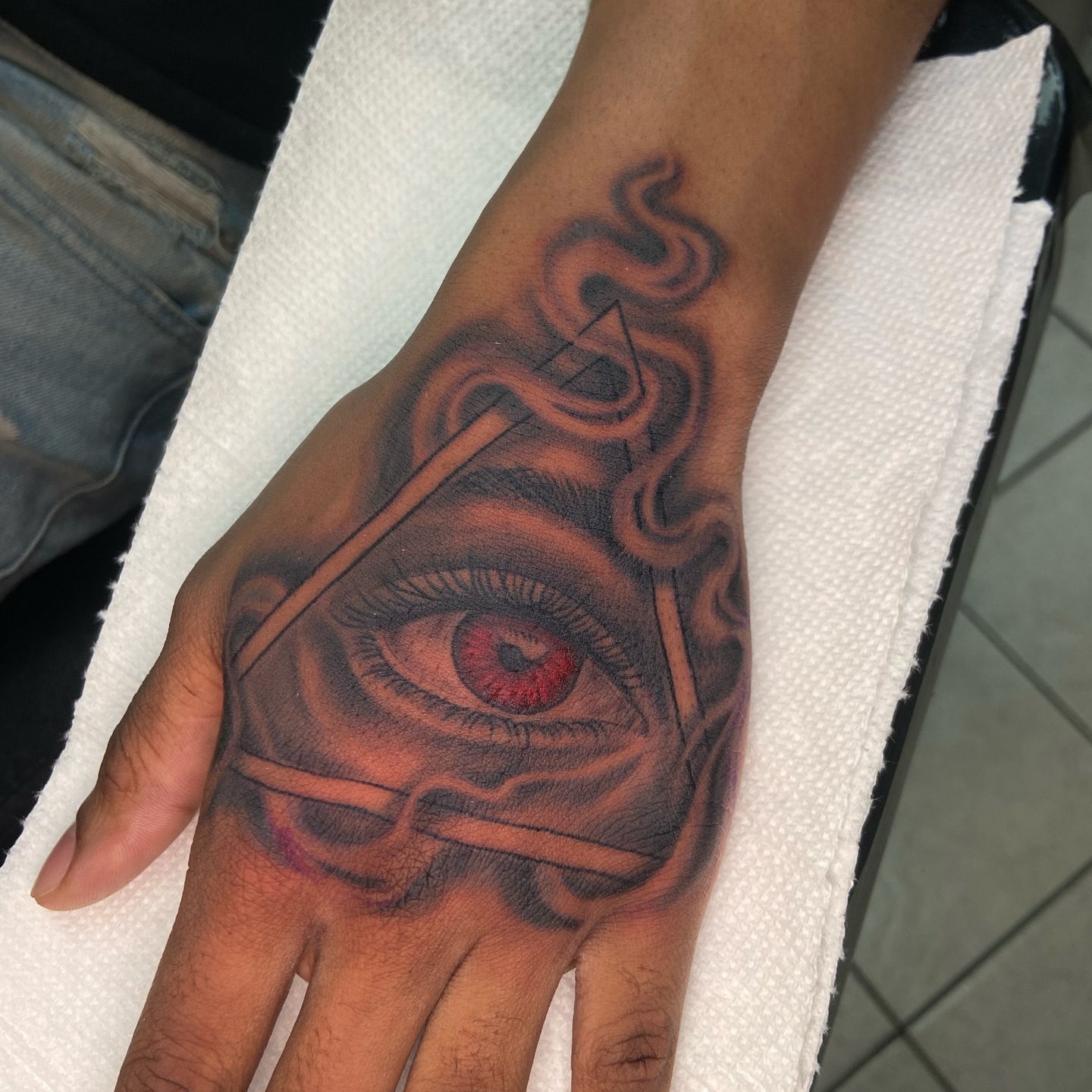 Eye with pyramid realism tattoo on the hand by Chicago Tattoo Artist
