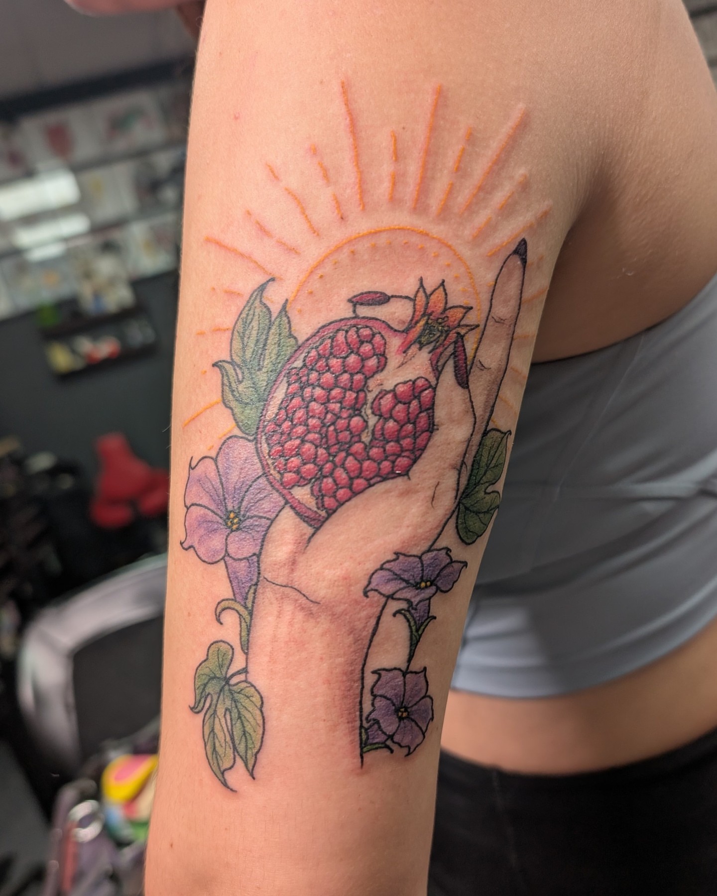 Pomegranate and flowers American traditional tattoo on the forearm by Trinity Renee