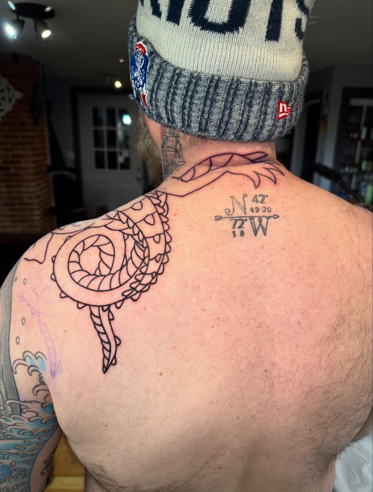 Nautical compass black and grey tattoo on the back by Nathanial Gagnon