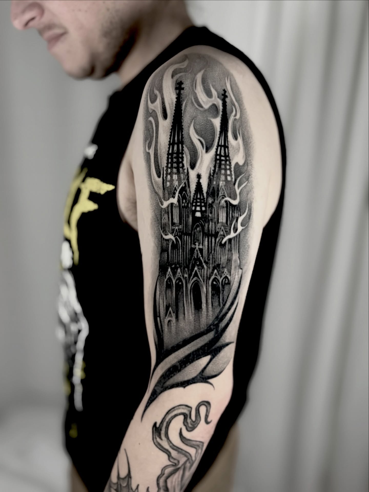 Cathedral black and grey tattoo on the upper arm by Bryan