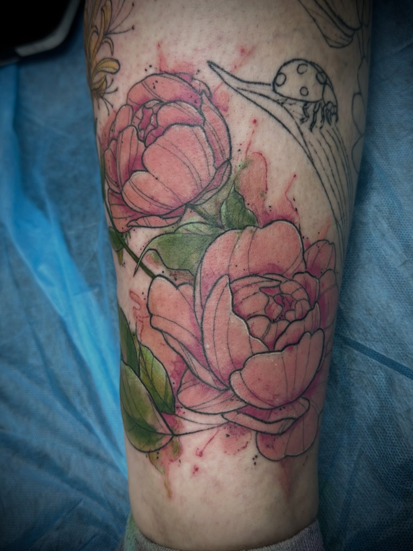 Peony flowers watercolor tattoo on the forearm by Chris Gray