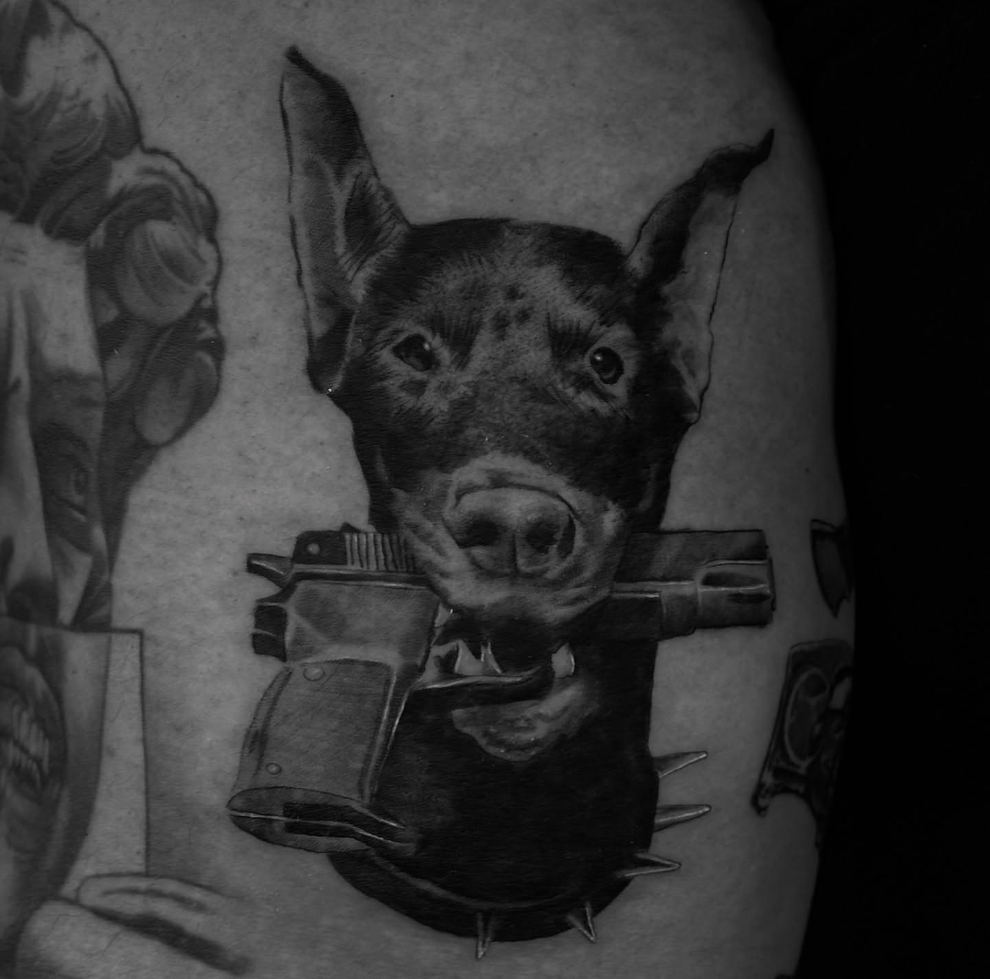 Dog with gun realism tattoo on the forearm by R O M y R I N C Ó N