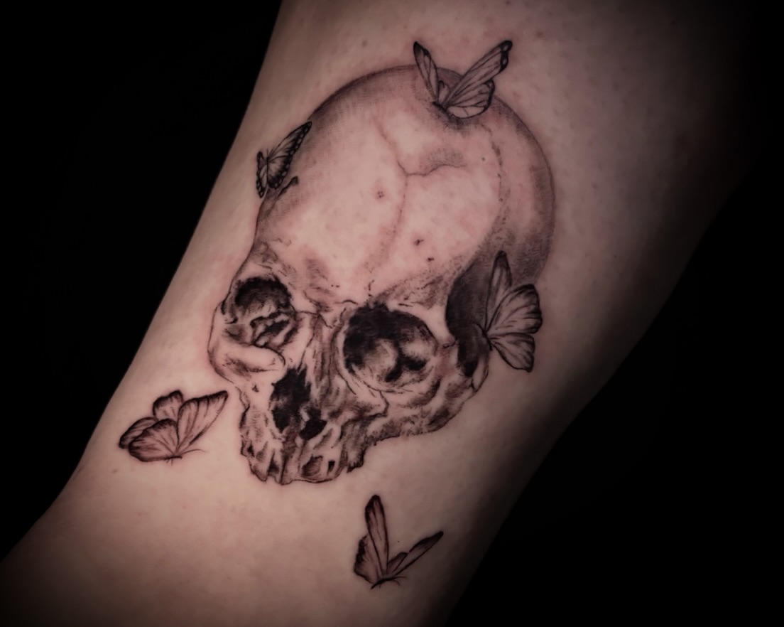 Skull with butterflies realism tattoo on the forearm by Tattoos by Marcy