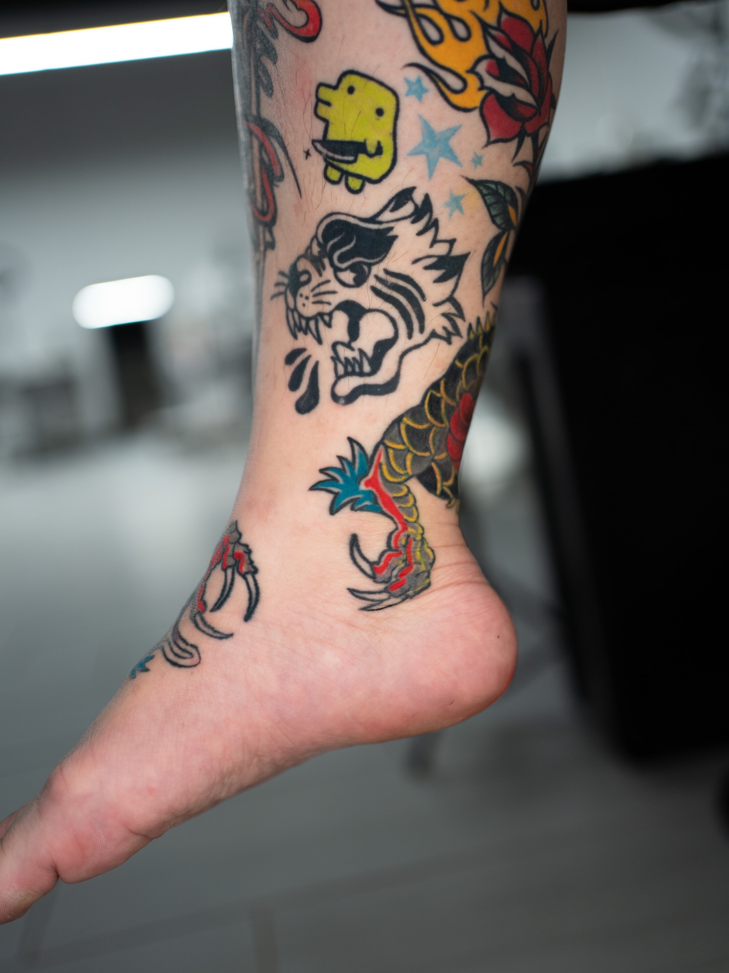 Tiger American traditional tattoo on the foot by Lancinglove