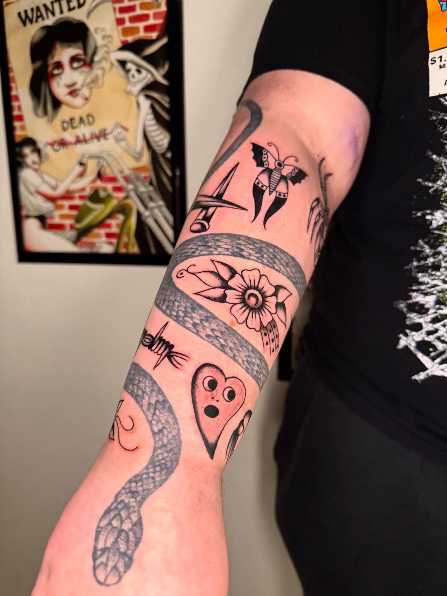 Snake and heart American traditional tattoo on the forearm by Cody Petkus