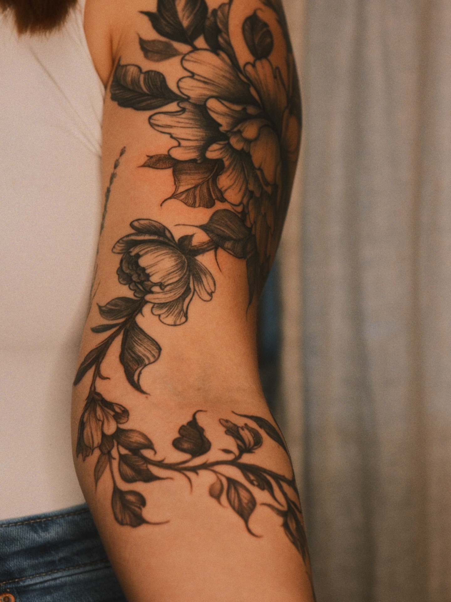 Floral design black and grey tattoo on the forearm by Brad Simmons
