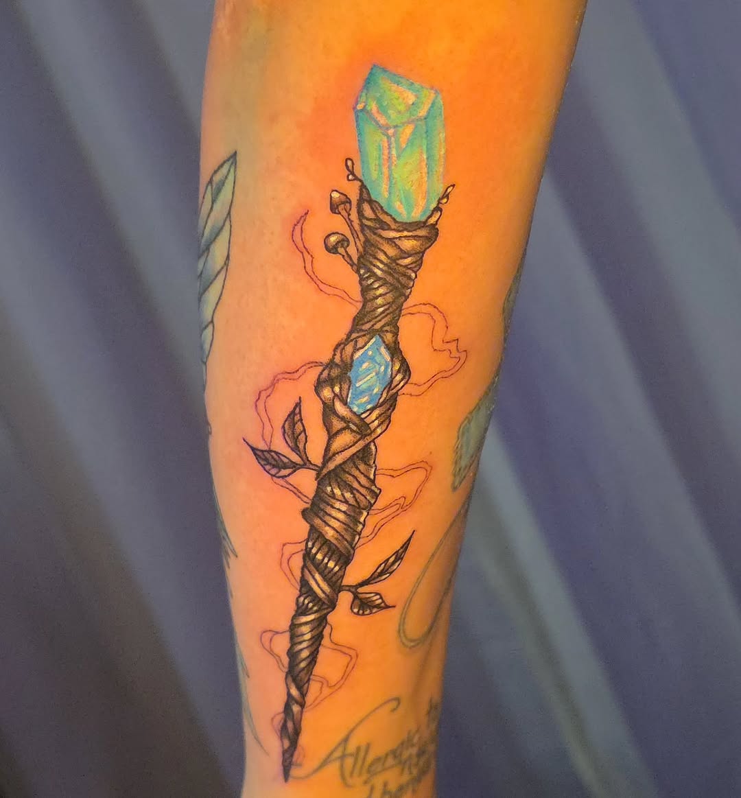 Crystal-topped staff tattoo on the forearm by Karley Michelle Moody