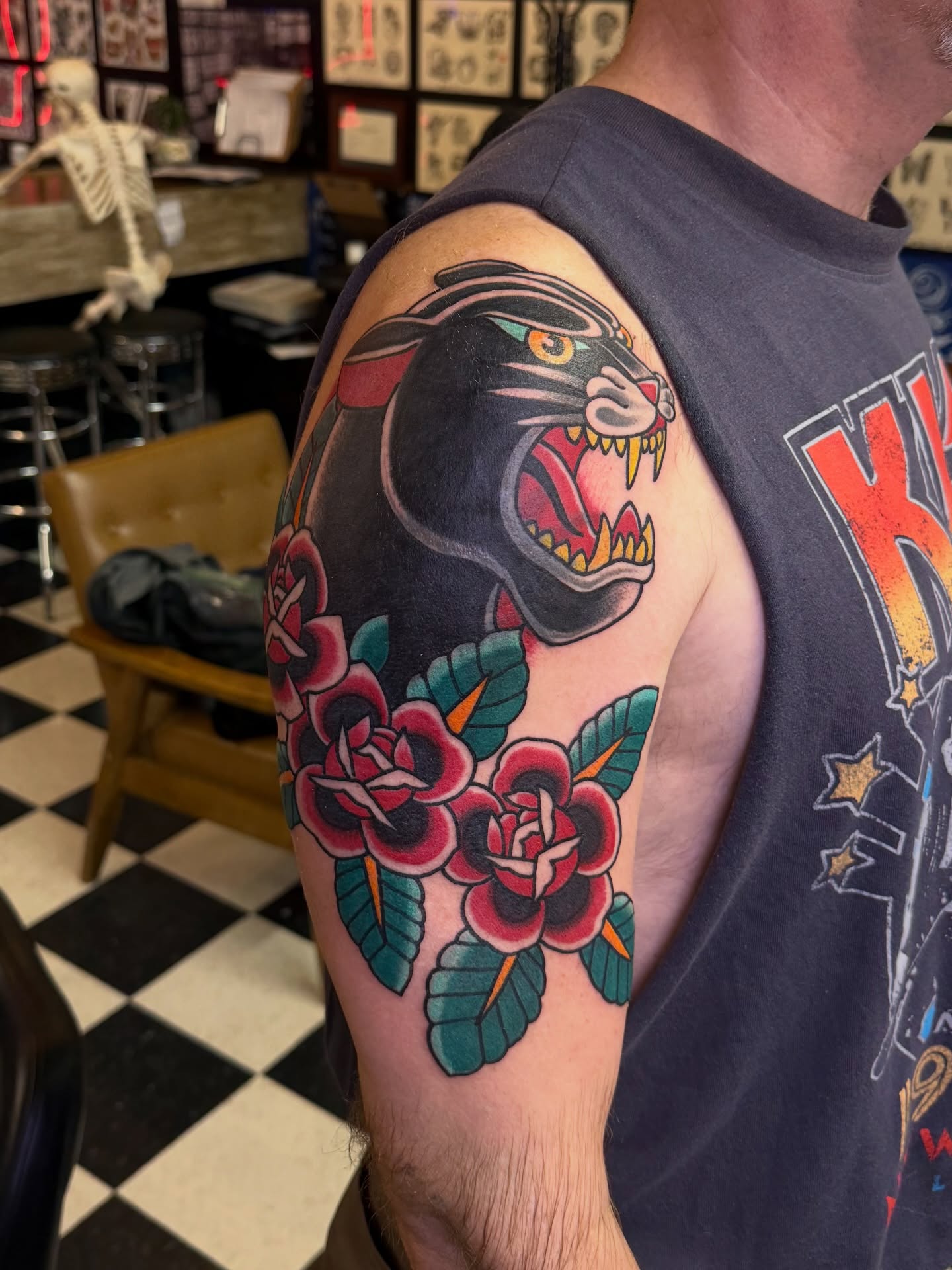 Panther and roses American traditional tattoo on the shoulder by Don Robison