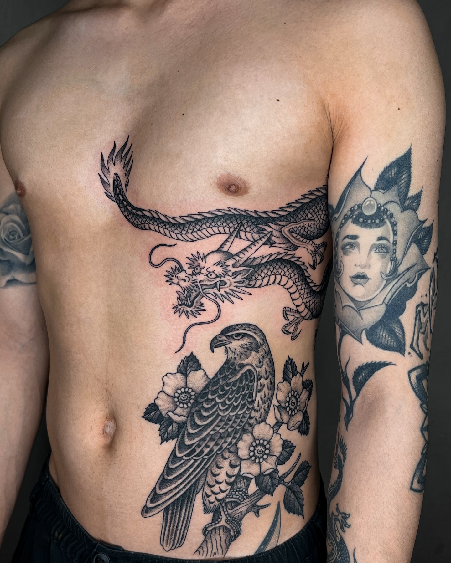 Eagle and flowers black and grey tattoo on the chest by Jae Traditional Tattoo