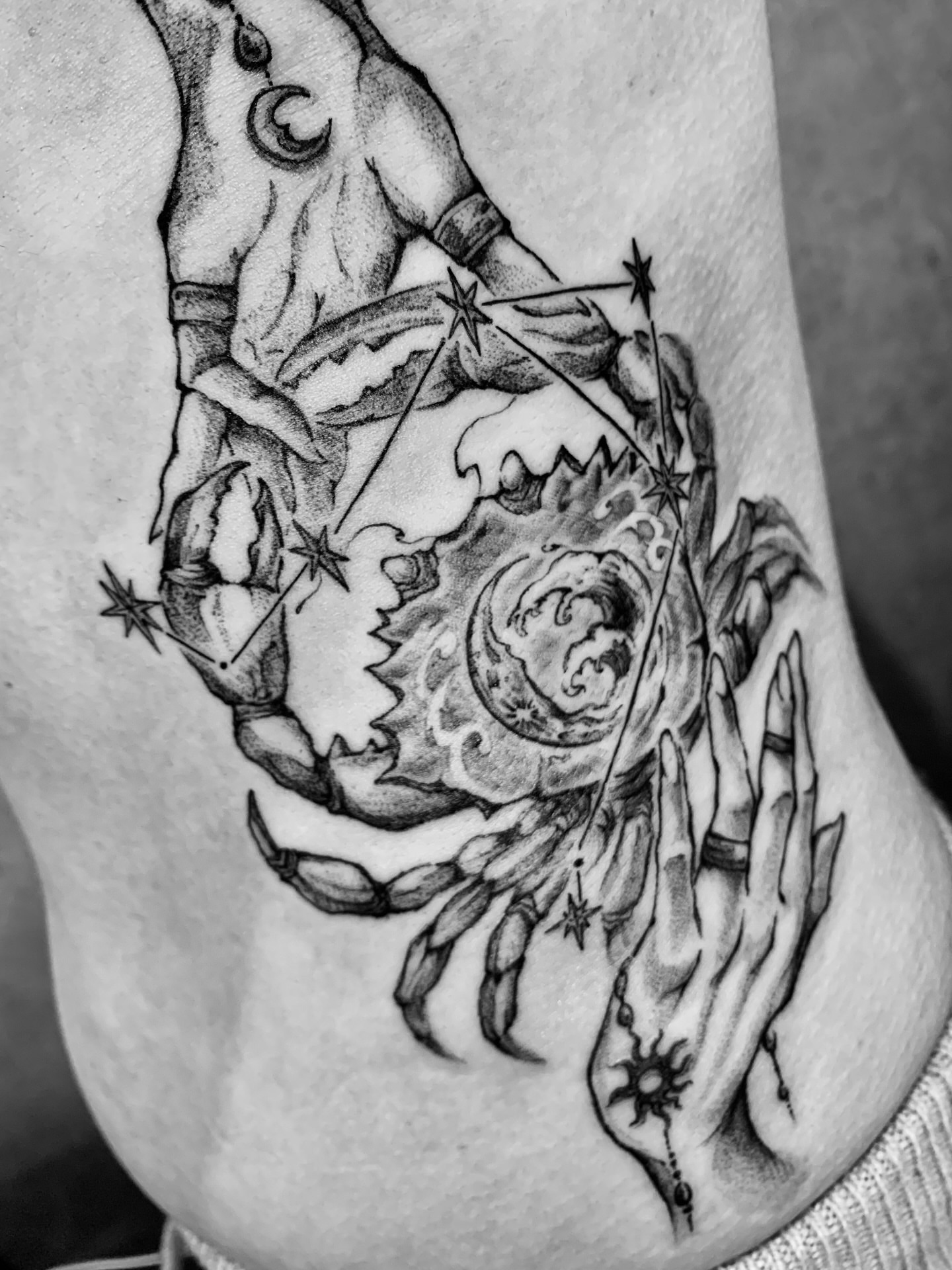 Crab and celestial symbols realism tattoo on the thigh by 21 tattooist