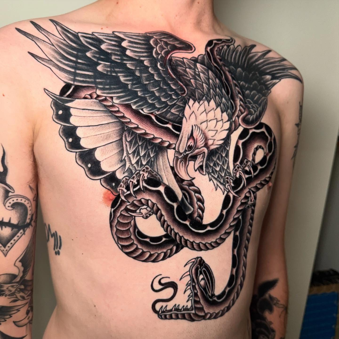 Dragon American traditional tattoo on the chest by Zac Chaffin