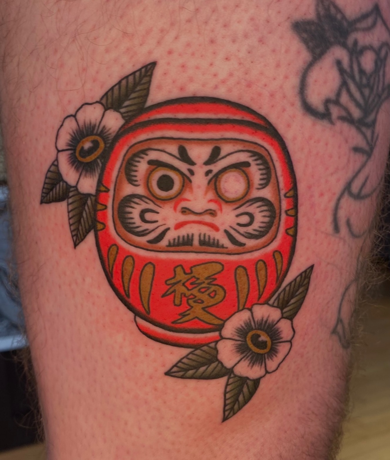 Daruma doll American traditional tattoo on the thigh by Will Allan Columbus tattoo artist