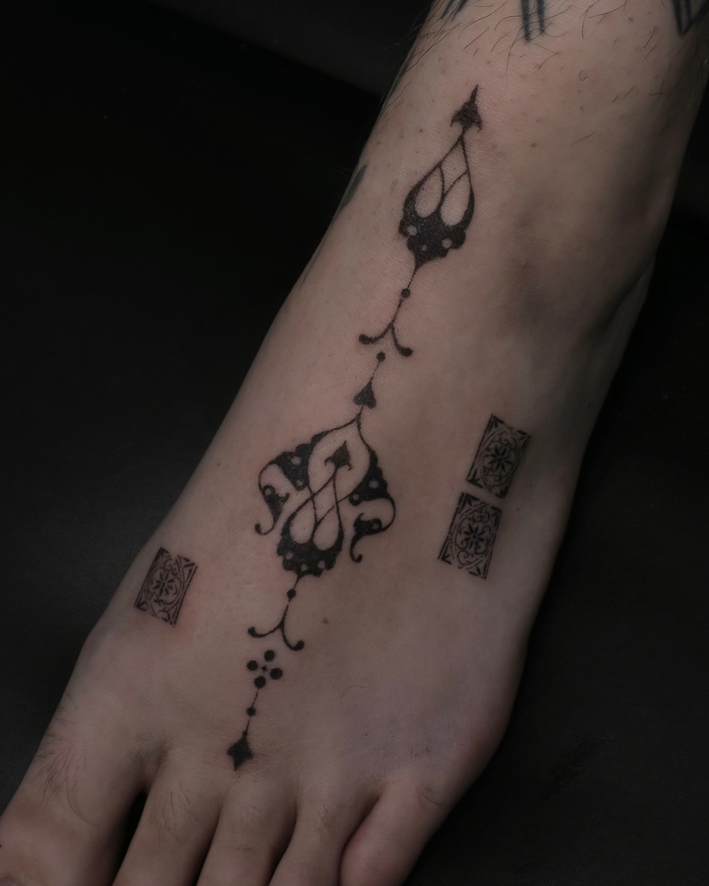 Abstract ornament dotwork tattoo on the foot by Olivia