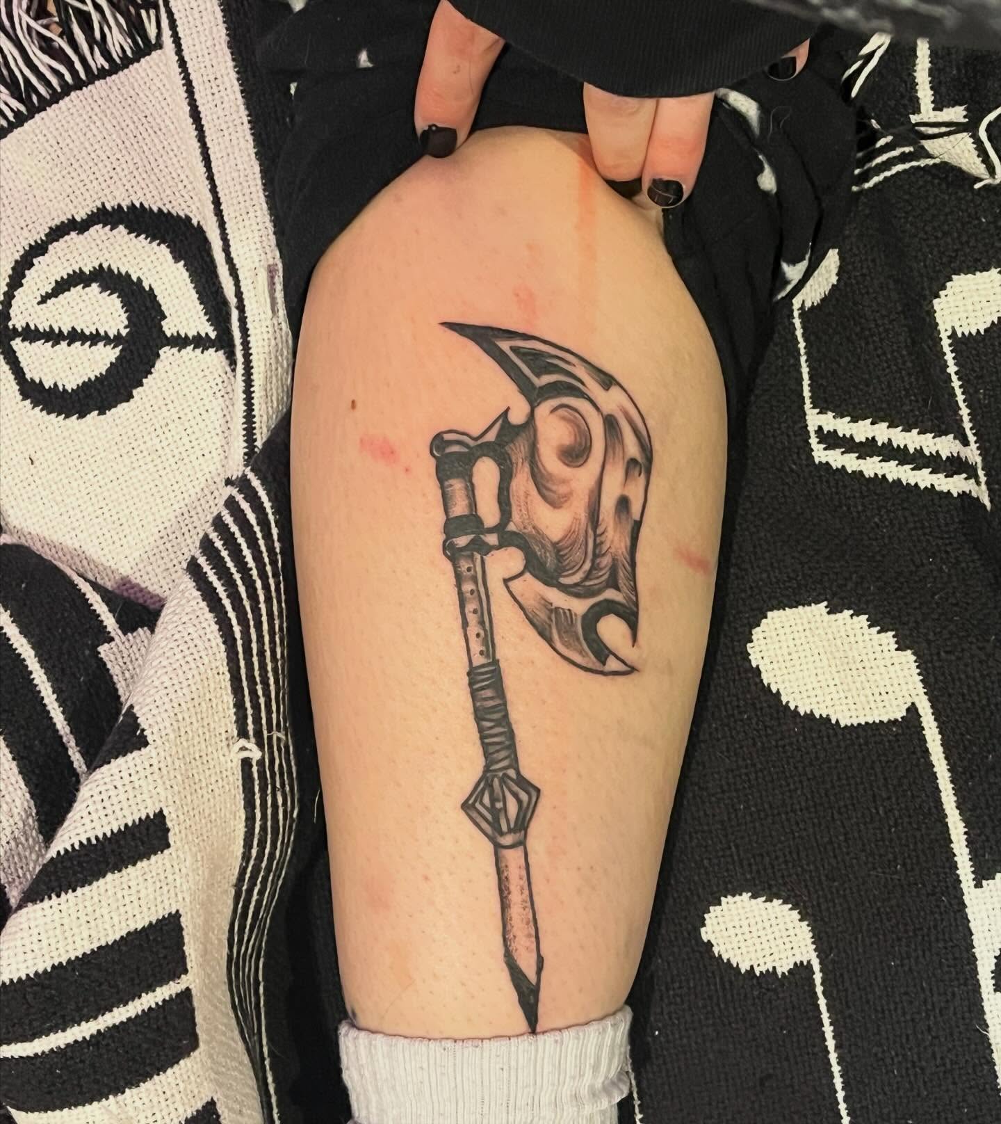 Spear and helmet black and grey tattoo on the forearm by ren