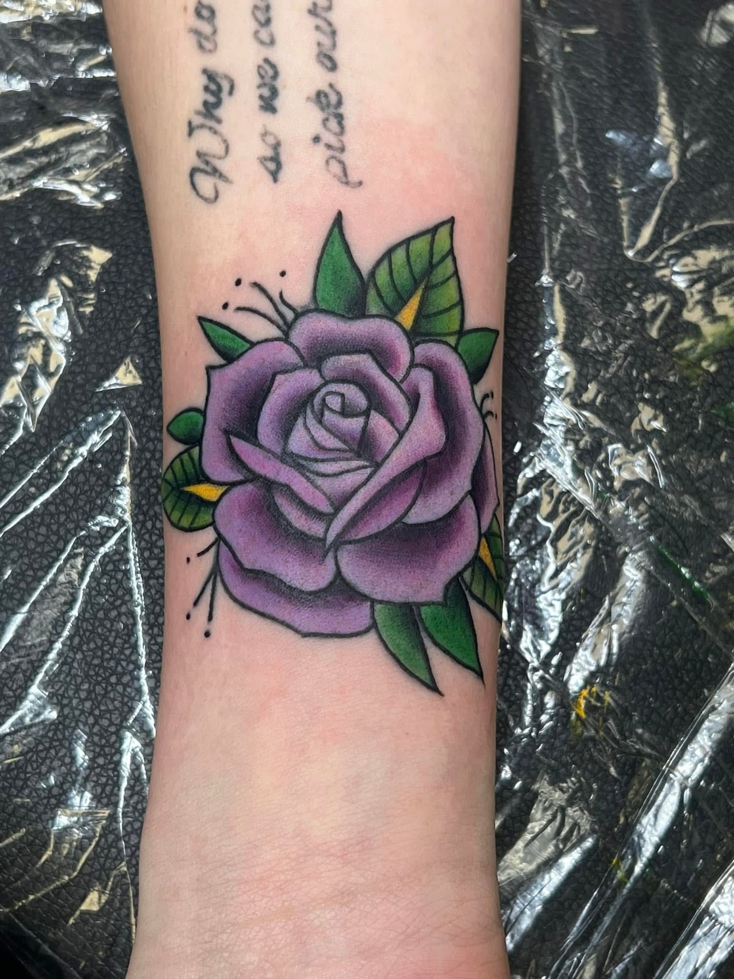 Purple rose American traditional tattoo on the forearm by Olivia Suzanne Fada