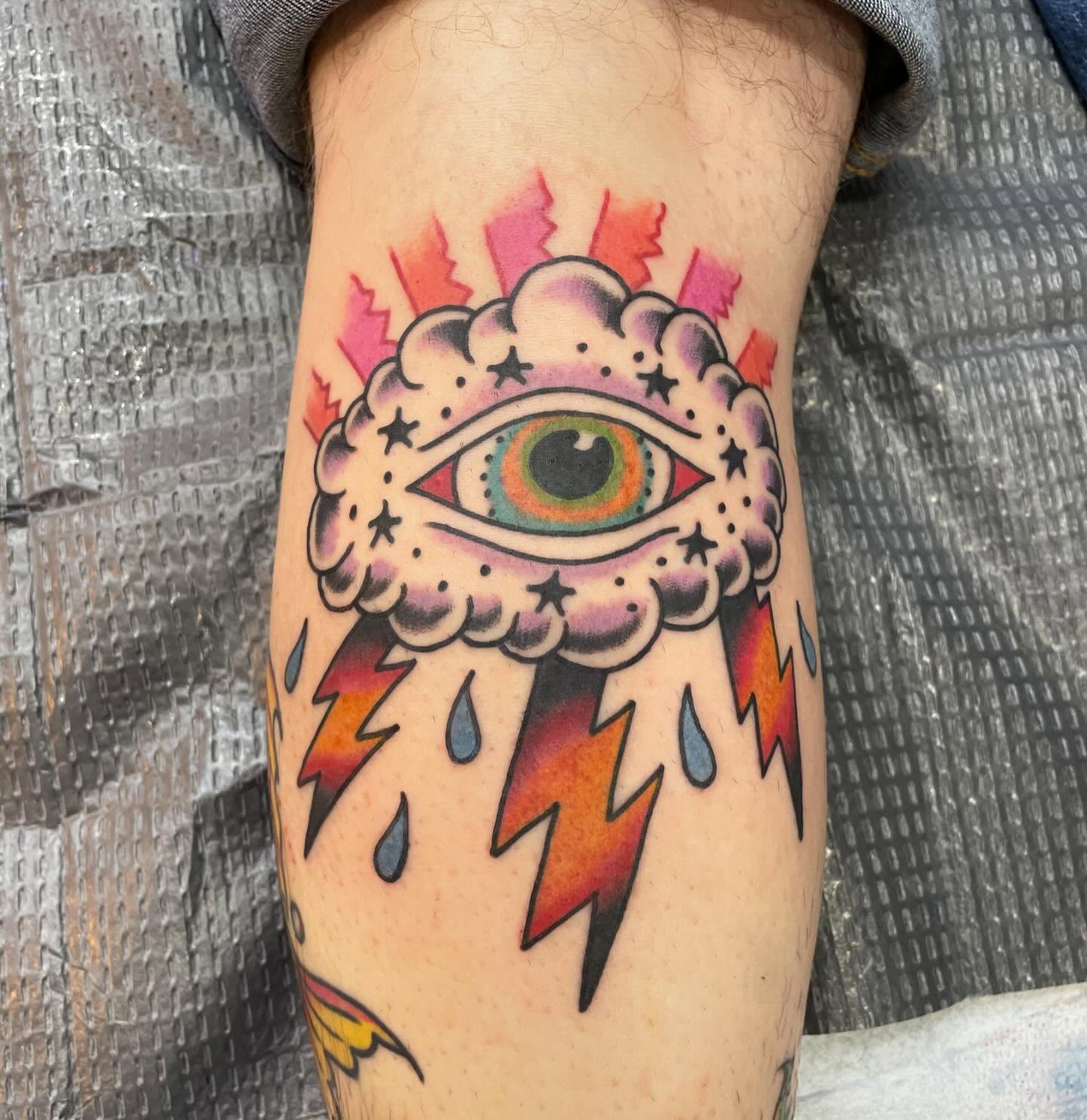 Eye with lightning bolts American traditional tattoo on the forearm by Lainy Lou