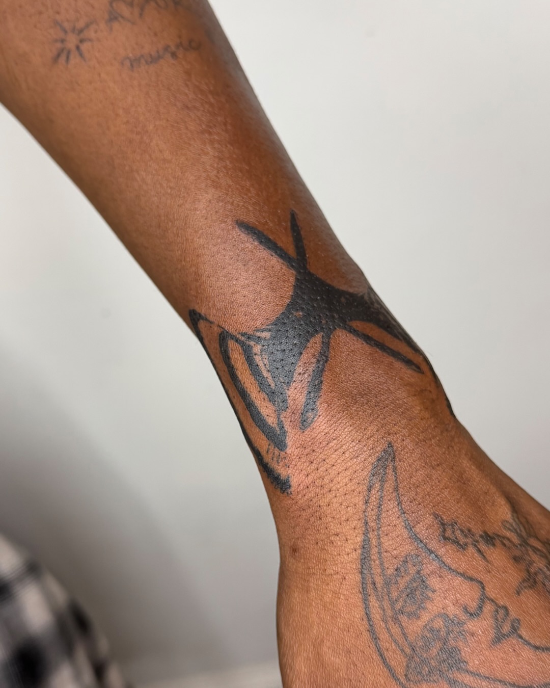 Starfish black and grey tattoo on the forearm by Haza