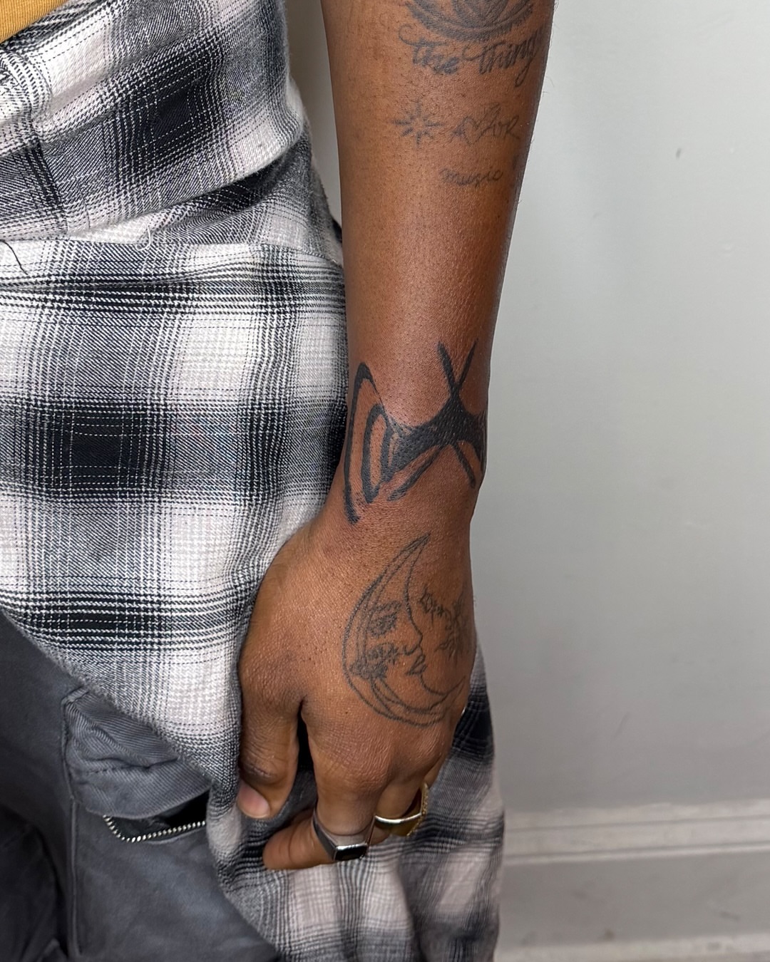 Moon and star black and grey tattoo on the forearm by Haza