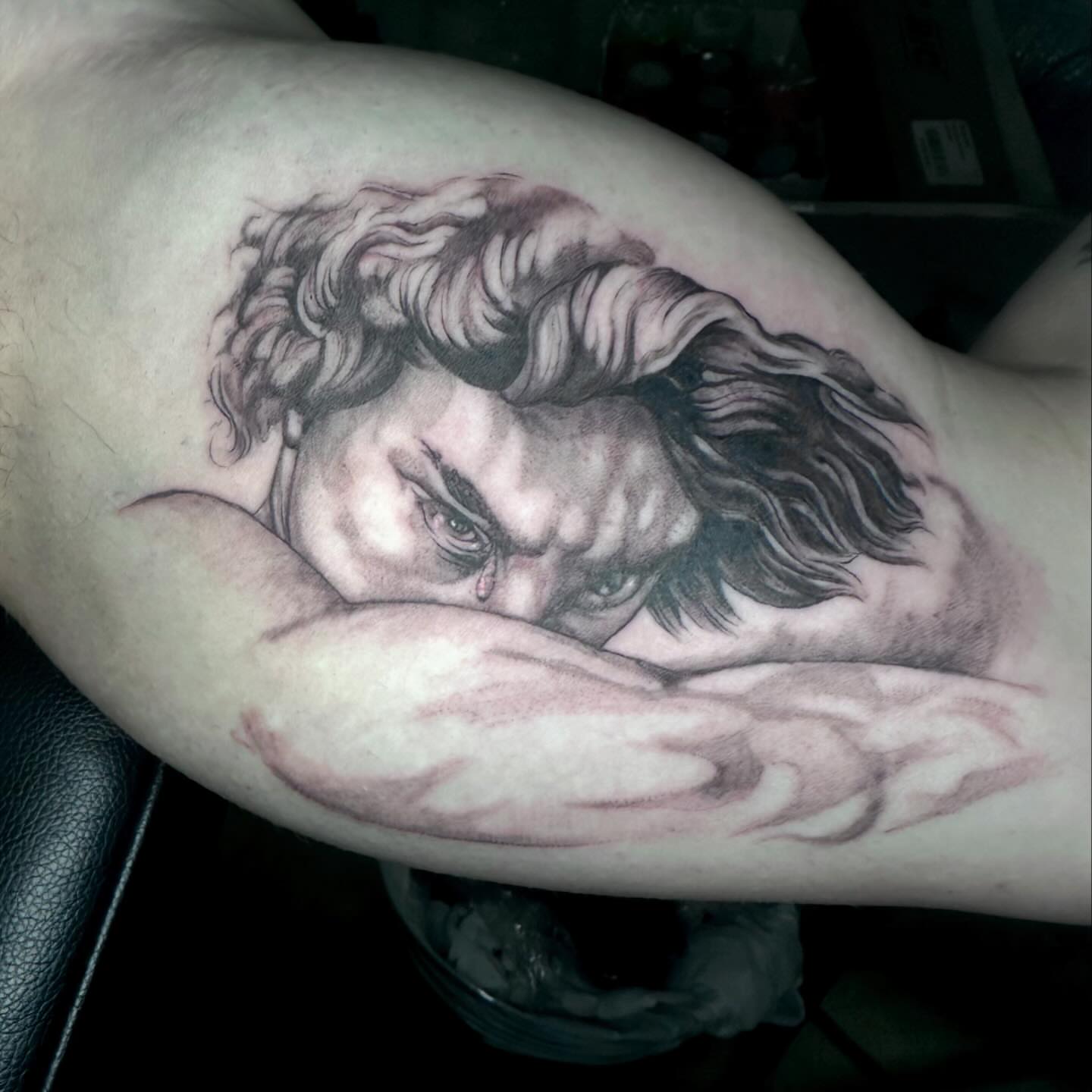 Angry man realism tattoo on the forearm by Quin Walker